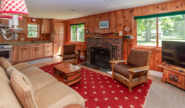 Takundewide lake view Cottage #13 living room with TV and fireplace
