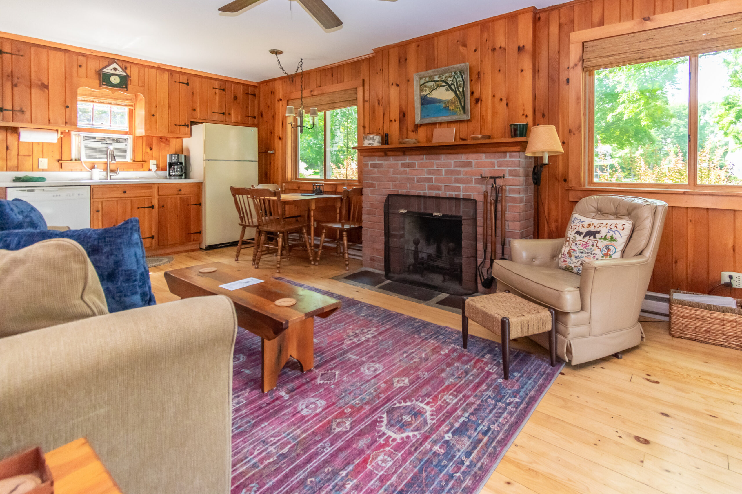 Lake George vacation cabin rental #11 living room with brick fireplace at Takundewide Cottages on Lake George